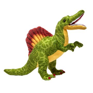 The Spinosaurus soft toy stands on its back two legs facing right, with its jaws open. Its body is mainly green with leopard-like spots, its underbelly is yellow and the 'sail' on its back is red and yellow. 