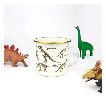 The Dinosaur Skeletons Mug styled with three toy dinosaur models looking at it.