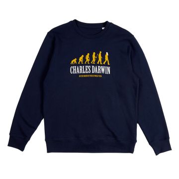 The front of the navy sweater has 6 figures evolving from an ape-shape on all fours to an upright human. Printed below is: ‘Charles Darwin On the Origin of Species World Tour’.