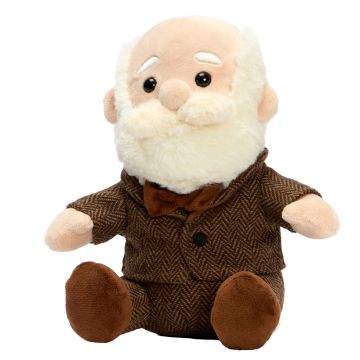 The Charles Darwin Soft Toy sits facing to the left. It wears a brown suit and bow tie, the face has black eyes and a white beard, moustache and eyebrows.