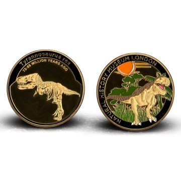 Both sides of the medal are shown. On the left is the skeleton of Tyrannosaurus rex and on the right is a coloured depiction of it next to trees.