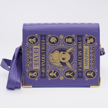 The purple crossbody bag has ‘The Multiple Evolutions of Eevee’ graphic in gold on the front, in the style of a scientific journal.