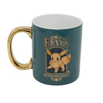 The teal mug has a gold illustration of Eevee and the words ‘Eevee The Evolution Pokémon’. The handle is gold and the inside is white.