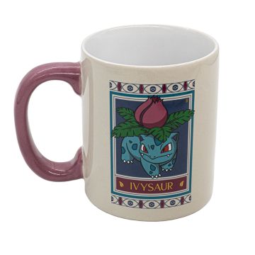 The cream mug features the Pokémon Ivysaur graphic in the style of the Natural History Museum’s botanical ceiling panels. The handle is pink.