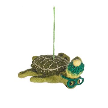 The light-green body of the turtle has a darker green shell and wears green goggles and bobble hat. It hangs from a green thread.