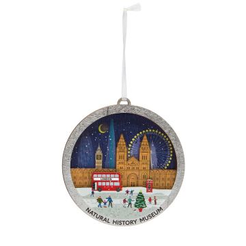 The round, wooden decoration depicts famous landmarks in London at night, including the Natural History Museum, and hangs on a white ribbon.