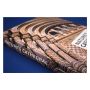 The book is shown laid on a blue surface and focuses on the book's spine and front cover picture, which is a close up of the arches and columns above the entrance to the Museum.