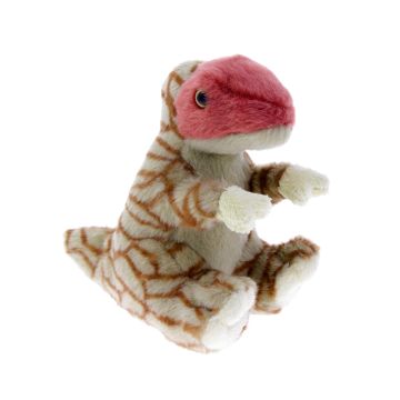 The T. rex is sitting facing towards the right. Its head is red and its body is pale green with brown scale markings.
