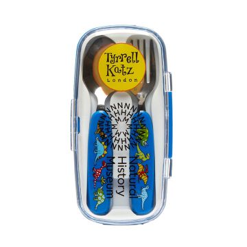 The spoon and fork with their blue handles are shown inside the closed case, which has a see-through lid. The front of the case has a round, yellow logo with the words ‘Tyrrell Katz London’ above the Natural History Museum logo in black.