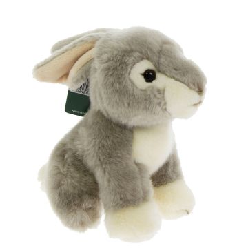 A side view of the light grey, furry toy, with the ears folded behind the head. The front paws, chest, mouth and eye area are white.