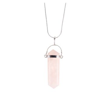 A close up of the rose quartz pendant at the bottom of its silver plated chain. The pale pink stone is shaped like a prism, with a silver plated bar and arched bail (attachment) at the top.