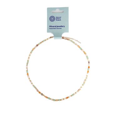 The necklace shown with its packaging label on a white background. Each round stone is a different colour and separated by a gold decorative bead. The stone's pale colours include green, pink and orange.