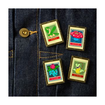 All four pin badges shown on a denim shirt.