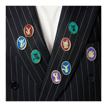 All eight pin badges shown on the lapels of a pin-striped jacket. There are two each of either teal, burgundy, blue or purple and each badge depicts a different evolution of the Pokémon Eevee.