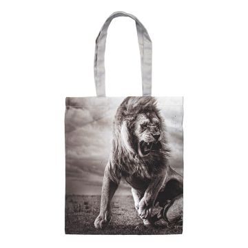 One side of the black and white Stormy Scene Tote Bag showing the male lion roaring with clouds behind him.