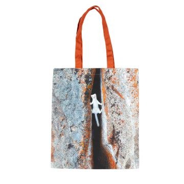 One side of the tote bag shows a colour image of an ermine straddled across a crevice as it chases prey between rocks. The handles are orange.