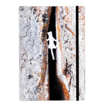 The notebook’s front cover is a photo of an ermine clambering across a crevice. There is a black elastic strap on the right of the cover.