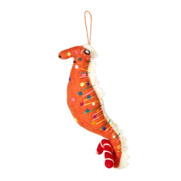 The orange body of the seahorse has a white spine and is covered in different coloured spots. It holds a red and white candy cane in its tail.