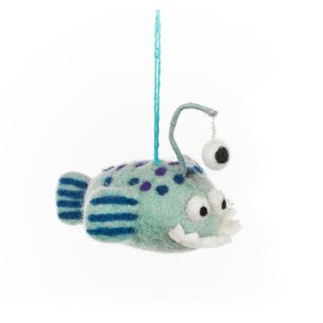The light blue body of the felt fish has darker blue dots on top and stripes on its tail and fins. The lower jaw has an underbite with white teeth and the lure has a third eye dangling from it.
