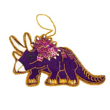 The purple Triceratops has white horns, claws and beak. The outline of its body is edged in glittery gold thread and its neck frill is covered in purple sequins.