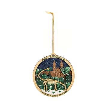 The round, wooden Fern the Diplodocus decoration hangs on a gold ribbon.