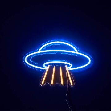 The sign as it looks when switched on in a dark room. The round flying saucer and domed cabin shape is outlined in bright blue, with four yellow fire thrusters below it. 