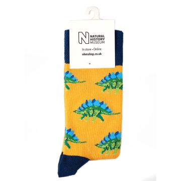 A pair of yellow and blue socks with green and blue stegosaurs on.