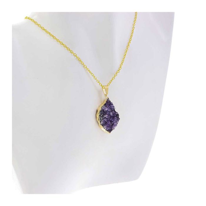 The necklace is displayed on the chest of a white bust. The pendant is purple and the chain is gold.