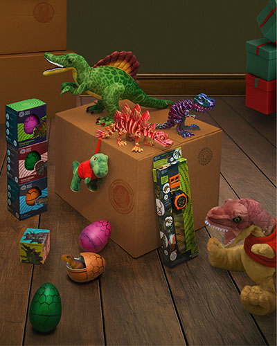 Different types of dinosaur-themed gifts are styled with parcel boxes, as if ready to send.